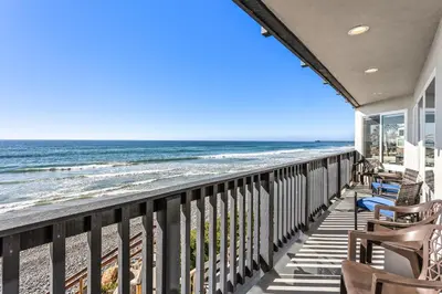 a view of the beach from the balcony of a house at Oceanfront Family Getaway - BBQ - Oceanfront Seating in Oceanside
