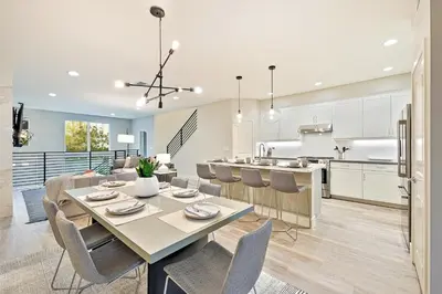 a kitchen and dining room with a table and chairs at Modern 4BR - Private Balcony - Garage Parking in Carlsbad