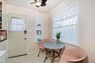 a room with a table and chairs and a window at Walk 2 Beach, EV Charger, Outdoor Dining, 2 Units in Carlsbad