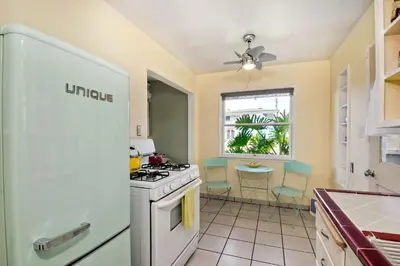 a kitchen with a white stove top oven next to a window at Walk 2 Beach, EV Charger, Outdoor Dining, 2 Units in Carlsbad