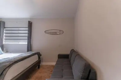 a bedroom with a bed and a couch in it at Not taking reservations in Chula Vista