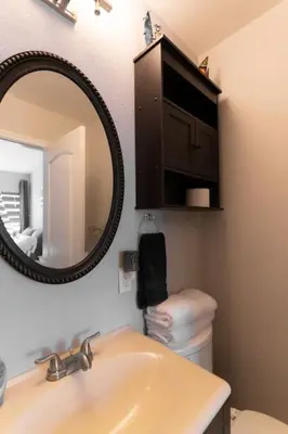a bathroom with a sink and a mirror and a toilet at Not taking reservations in Chula Vista