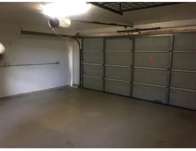 an empty garage with two garage doors and a light at Not taking reservations in Chula Vista