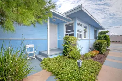 a blue house with a white door at Walk To Beach - EV Charger - Outdoor Dining - 2BR in Carlsbad