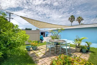 a patio with a table and chairs and plants at Walk To Beach - EV Charger - Outdoor Dining - 2BR in Carlsbad