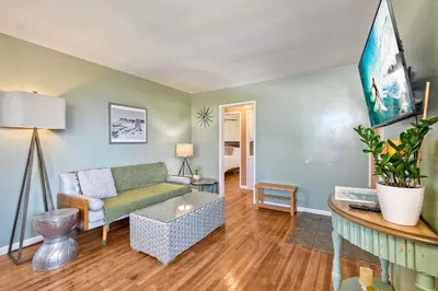 a living room with a couch and a table at Walk To Beach - EV Charger - Outdoor Dining - 2BR in Carlsbad
