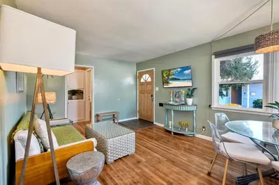 a living room with a table and a dining room at Walk To Beach - EV Charger - Outdoor Dining - 2BR in Carlsbad