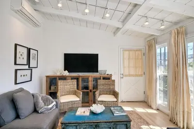 a living room with a couch and a tv at Walk To Beach & Village - 5 Bedrooms - 3 Units in Carlsbad