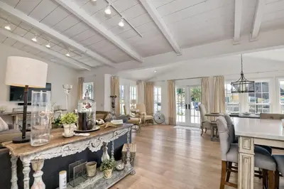 an open living room with a fireplace and a table at Walk To Beach & Village - 5 Bedrooms - 3 Units in Carlsbad