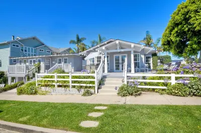 a house with a white fence in front of it at Walk To Beach & Village - 5 Bedrooms - 3 Units in Carlsbad
