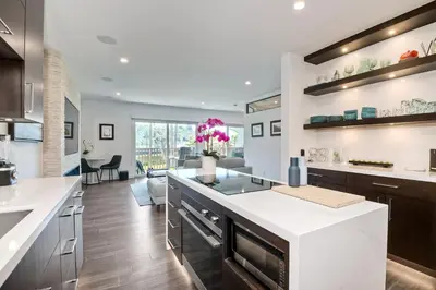 a kitchen with white countertops and a large island at La Costa Luxury Condo - Fully Remodeled in Encinitas