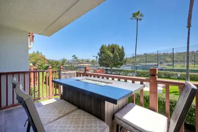 a porch with a table and chairs on a balcony at La Costa Luxury Condo - Fully Remodeled in Encinitas