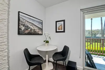 a room with a white table and chairs and a window at La Costa Luxury Condo - Fully Remodeled in Encinitas
