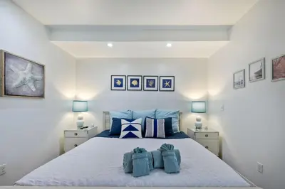 a bedroom with a bed with two towels on it at La Costa Escape - Pool, BBQ, Gated Parking in Encinitas