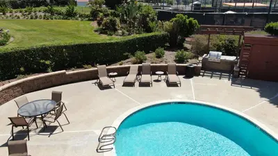 a swimming pool with chairs and a table and chairs at Private Balcony Overlooking Pool - Gated Parking in Encinitas