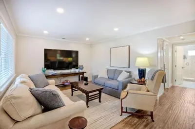 a living room with two couches and a tv at 90 Walk Score, Steps to Beach, Dining in Carlsbad