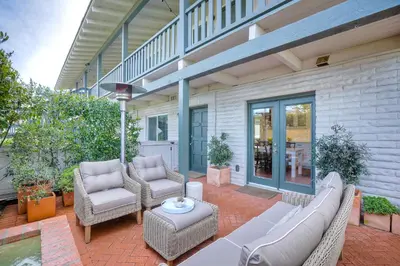 a patio with a couch and chairs and a table at 90 Walk Score, Steps to Beach, Dining in Carlsbad