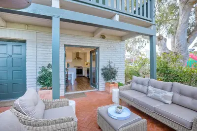 a porch with a couch and chairs on a patio at 90 Walk Score, Steps to Beach, Dining in Carlsbad
