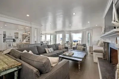 a living room with a couch and a table at Luxury Ocean Views - 6 BR Home - Steps to Sand in Carlsbad