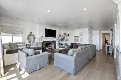 a living room with two couches and a fireplace at Luxury Ocean Views - 6 BR Home - Steps to Sand in Carlsbad