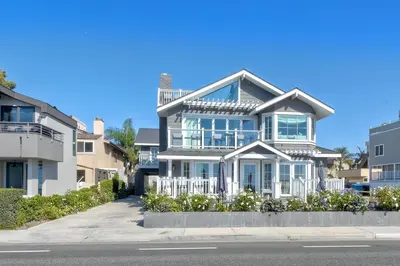 a large house on the side of a street at Luxury Ocean Views - 6 BR Home - Steps to Sand in Carlsbad
