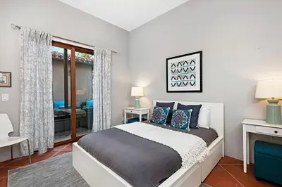 a bedroom with a large bed and a window at Rooftop Oceanview Patio - 5BR Remodeled Home in Carlsbad