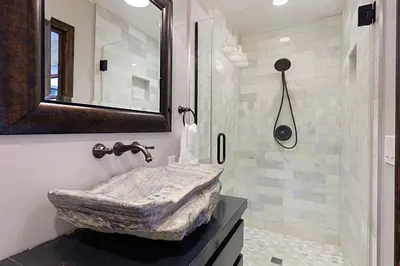 a bathroom with a stone sink and a shower at Rooftop Oceanview Patio - 5BR Remodeled Home in Carlsbad