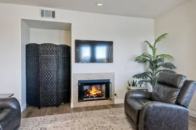 a living room with a couch and a fireplace at Lagoon Views - Pool - Hot Tub - Gated Community in Carlsbad