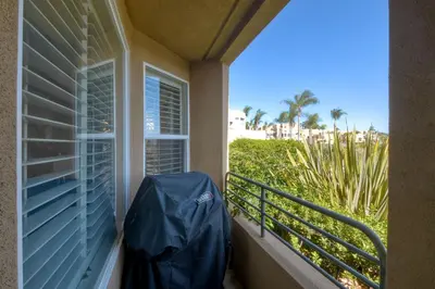 a balcony with a blue tarp next to a window at Lagoon Views - Pool - Hot Tub - Gated Community in Carlsbad