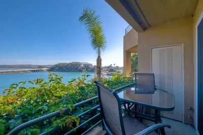 a balcony with a table and a laptop on it at Lagoon Views - Pool - Hot Tub - Gated Community in Carlsbad