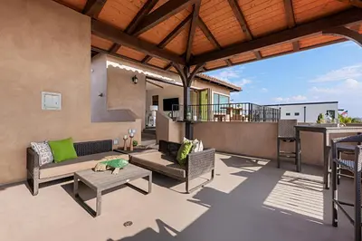 a patio with a couch and a table at Oceanview Rooftop Patio - Walk To The Beach & Park in Carlsbad