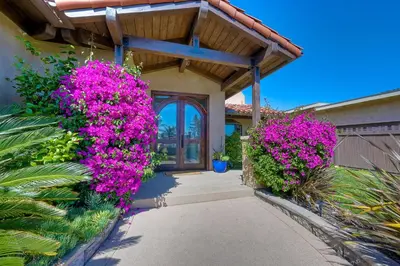 a entrance to a house with pink flowers at Walk To The Beach - Outdoor Dining - Spacious in Carlsbad