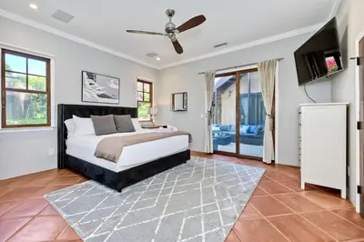 a bedroom with a bed and a ceiling fan at Walk To The Beach - Outdoor Dining - Spacious in Carlsbad