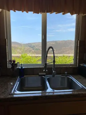 a kitchen sink with a view of a window at Acres of Bliss - A hillside getaway in Ramona