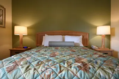 a bedroom with a large bed with two lamps at Aquamarine Villas in Oceanside