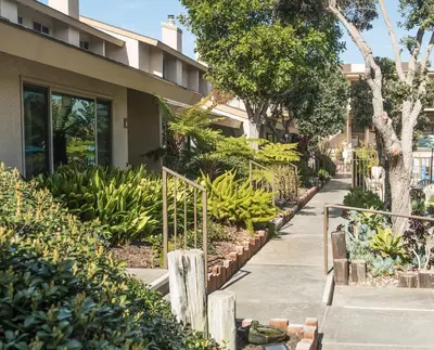 a sidewalk with a bunch of bananas in front of a building at Aquamarine Villas in Oceanside