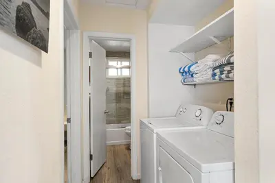 a white laundry room with a washer and dryer at Windansea Coastal Haven - Steps to Beach in San Diego