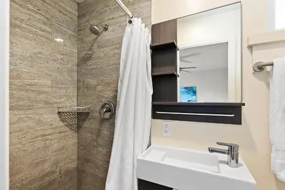a bathroom with a sink and a shower at Windansea Coastal Haven - Steps to Beach in San Diego