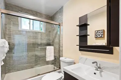 a bathroom with a shower and a toilet and a sink at Windansea Coastal Haven - Steps to Beach in San Diego