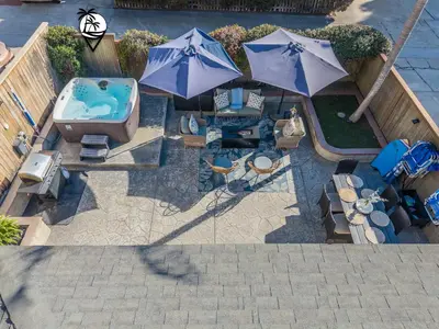 an overhead view of a patio with a tub and umbrellas at Windansea Coastal Haven - Steps to Beach in San Diego