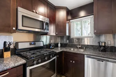 a kitchen with a stove and a microwave at Windansea Coastal Haven - Steps to Beach in San Diego