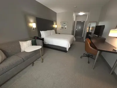 a hotel room with a bed and a couch at Holiday Inn Carlsbad/San Diego by IHG in Carlsbad