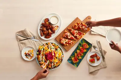 a table with plates of food and plates of food at Holiday Inn Carlsbad/San Diego by IHG in Carlsbad