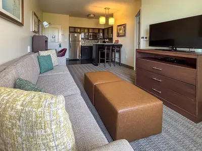 a living room with a couch and a flat screen tv at Staybridge Suites Carlsbad/San Diego by IHG in Carlsbad