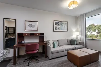 a living room with a desk and a couch at Staybridge Suites Carlsbad/San Diego by IHG in Carlsbad