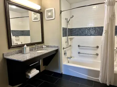 a bathroom with a tub and a sink and a shower at Staybridge Suites Carlsbad/San Diego by IHG in Carlsbad