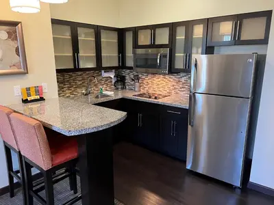 a kitchen with a stainless steel refrigerator and a counter at Staybridge Suites Carlsbad/San Diego by IHG in Carlsbad