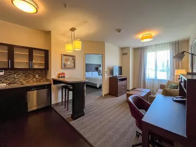 a hotel room with a living room and a bedroom at Staybridge Suites Carlsbad/San Diego by IHG in Carlsbad