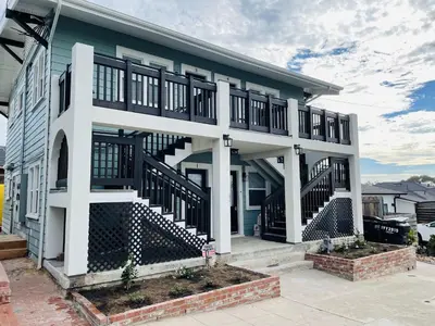 a house with a staircase in front of it at The Heron On Ivy in San Diego