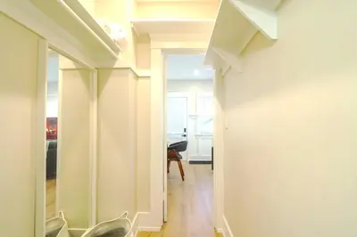 a hallway with white walls and a room with a desk at The Heron On Ivy in San Diego